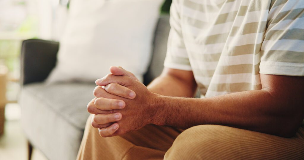 Hands resting together in a quiet moment, representing the need for pause and support during ADHD burnout