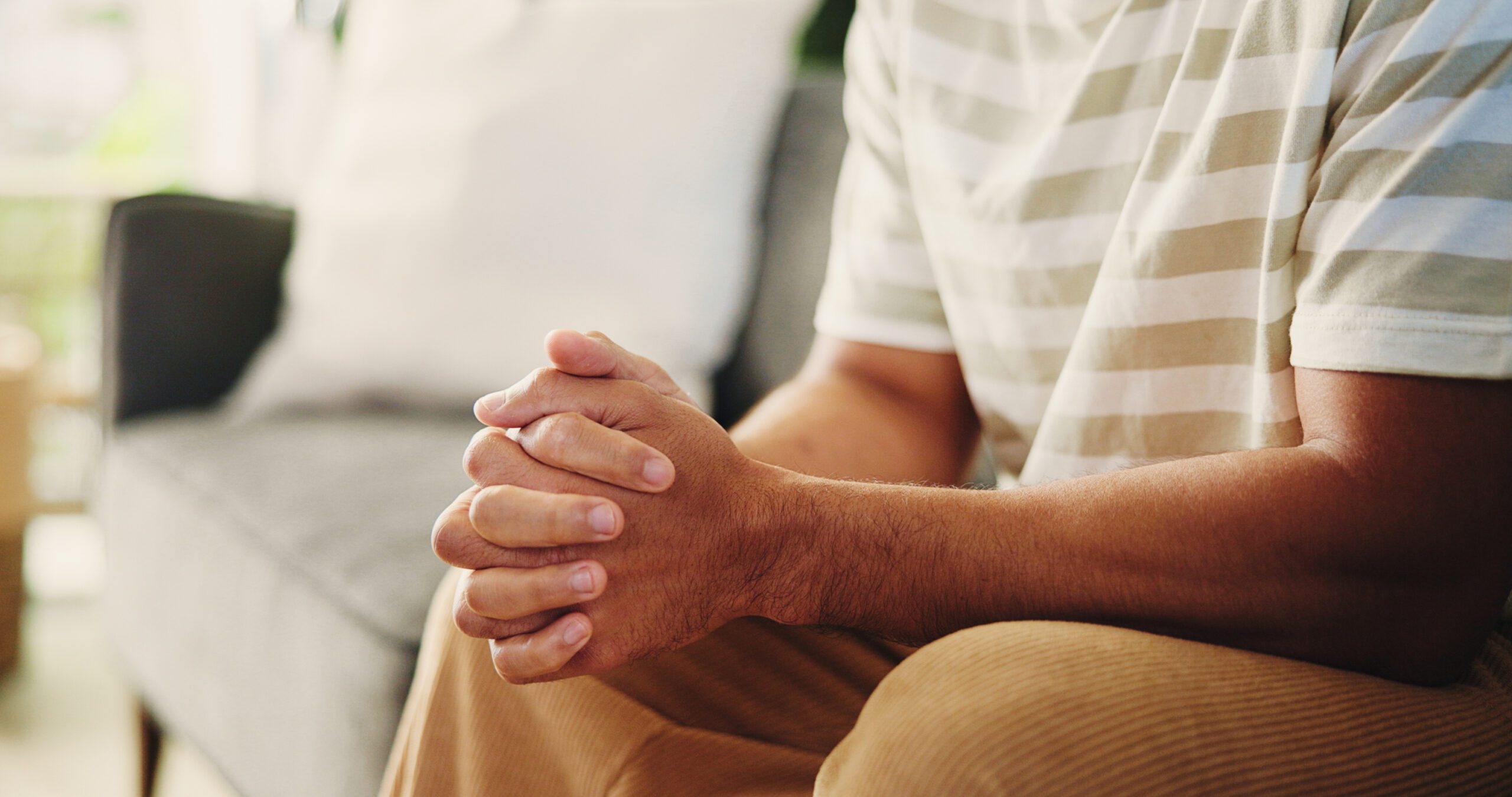 Hands resting together in a quiet moment, representing the need for pause and support during ADHD burnout